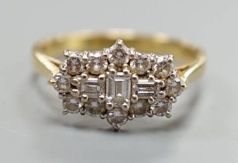 A modern 18ct gold and diamond cluster dress ring, size P, gross weight 4.2 grams, set with round and baguette cut stones.